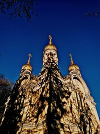 Low angle view of statue against blue sky