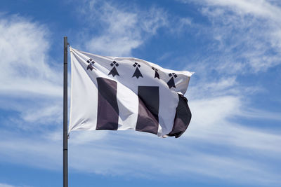 Flag of the city of rennes waving in mid air.