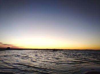 Scenic view of sea against clear sky during sunset