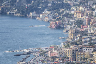 High angle view of sea and buildings in city