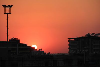 Low angle view of silhouette buildings against sky during sunset