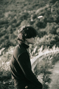 Man sitting against trees