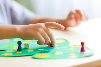 Close-up of woman playing with ball on table