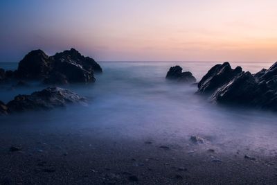 Scenic view of sea against clear sky at sunset