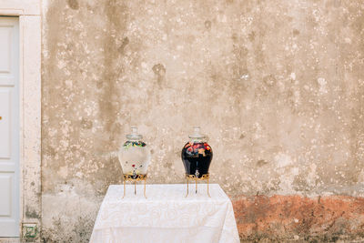 Rear view of couple standing against wall