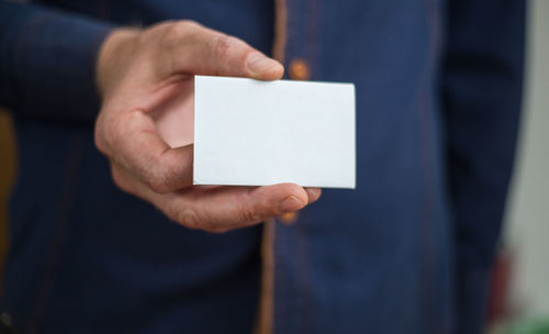 Close-up of human hand holding paper