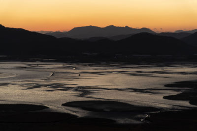 Scenic view of silhouette mountains against sky during sunset