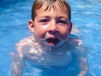 Portrait of boy swimming in pool