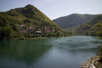 Scenic view of lake and mountains against clear sky
