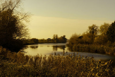 Scenic view of lake against sky during sunset