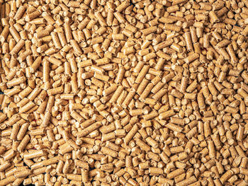 Natural wooden pellets background as renewable energy. close-up wood pellet pattern. top view