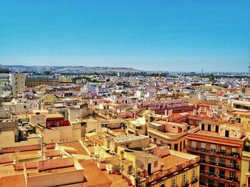 High angle view of townscape against blue sky