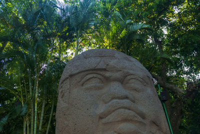 Low angle view of statue against trees