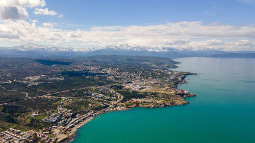 High angle view of sea and cityscape against sky