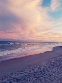 Scenic view of beach against sky during sunset