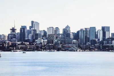 Buildings in city against clear sky