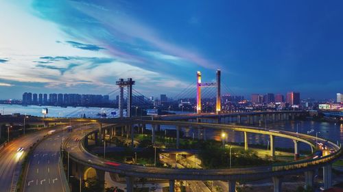 Illuminated cityscape against sky