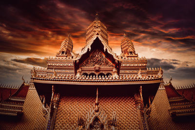 Low angle view of traditional building against sky during sunset