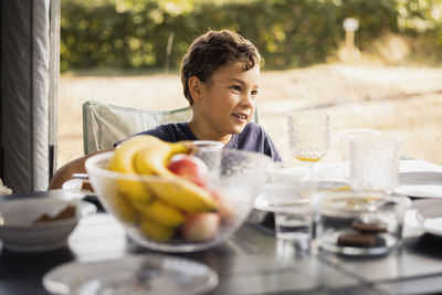 Boy sitting at picnic table