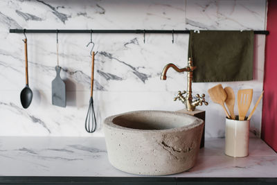 Stone washbasin with vintage mixer on marble kitchen background