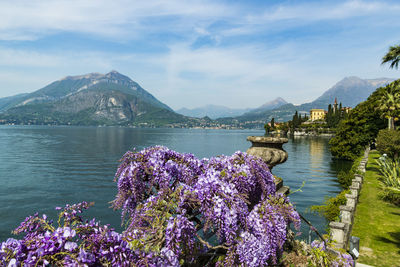 Scenic view of lake against mountains and cloudy sky