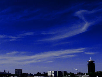 Low angle view of buildings against cloudy sky