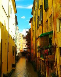 Alley amidst buildings in city