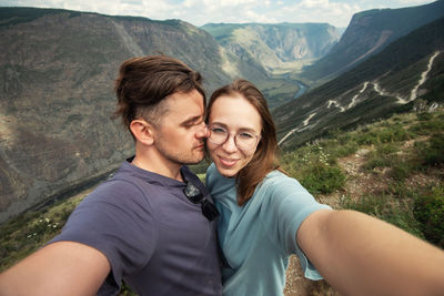 Portrait of young couple holding hands in mountains