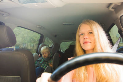 Portrait of girl sitting in car