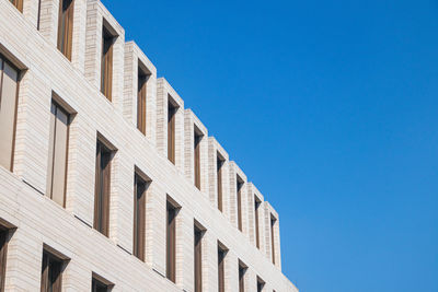 Low angle view of building against clear blue sky