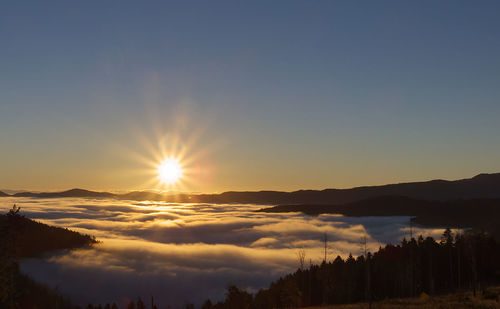 Scenic view of silhouette mountains against sky during sunset