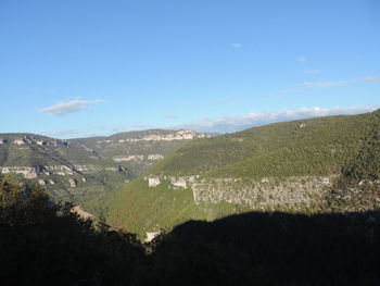 Scenic view of landscape against blue sky