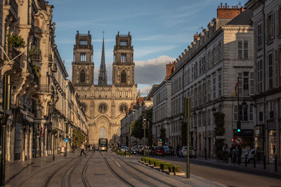 Street amidst buildings in town against sky