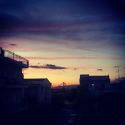 Buildings against sky at sunset