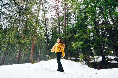 Woman standing in forest