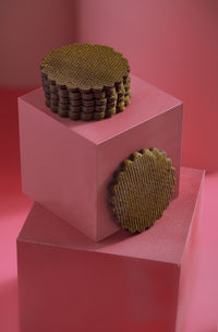 Close-up of cupcakes on table against red background