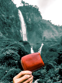 Person holding ice cream in water