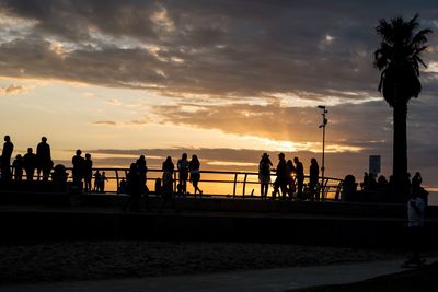 People on beach at sunset