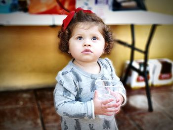 Cute girl holding disposable cup with ice