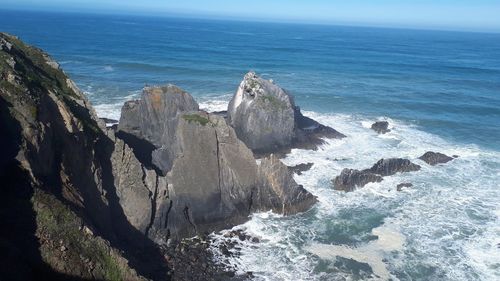 Panoramic view of rocks on beach against sky