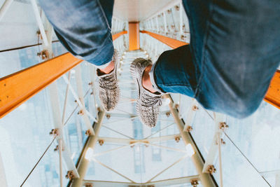 Low section of people standing on tiled floor