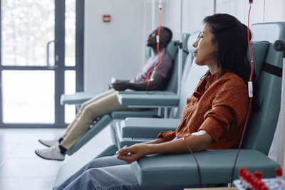 Man and woman donating blood in hospital