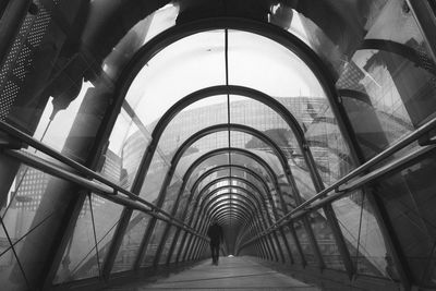 Rear view of a man walking in tunnel