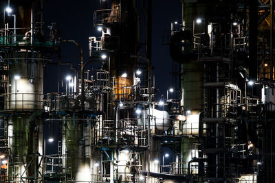 Low angle view of illuminated factory at night