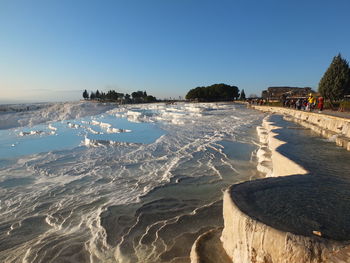 Scenic view of sea against clear blue sky