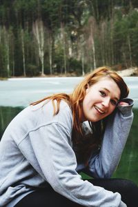 Portrait of smiling young woman sitting outdoors