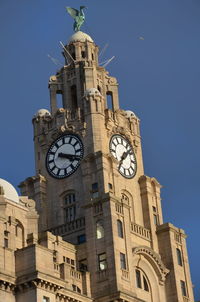 Low angle view of clock tower against sky