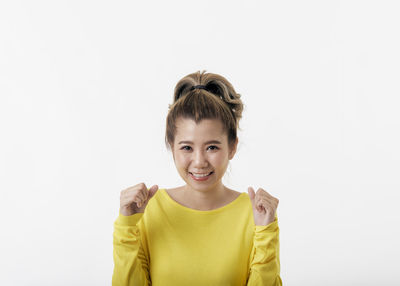 Portrait of a smiling young woman over white background