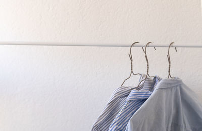 Clothes on hangers, blue shirts on a white background, shopping, clothes wardrobe