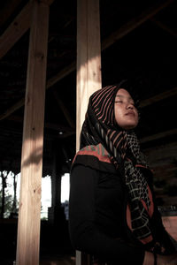 Woman looking away while standing on floor